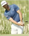  ?? — USA Today Sports ?? Dustin Johnson chips up to the first green during a practice round of the US Open tournament at Erin Hills.