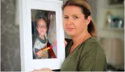  ??  ?? Maria Coyne with a pictured of Gavin (10), who died in a UK hospital waiting for a transplant