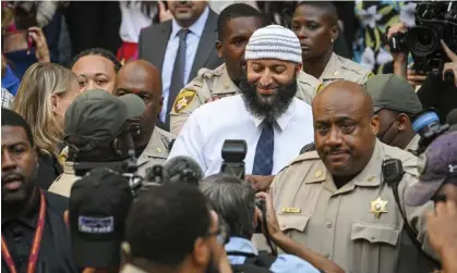  ?? Photograph: Jerry Jackson/AP ?? Adnan Syed, center, exits the Cummings courthouse a free man after a Baltimore judge overturned his 1999 murder conviction, on Monday.