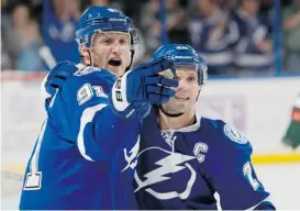  ?? Scott Audette/Getty Images ?? The hopes of Marty St. Louis, right, to be picked to the Canadian Olympic hockey team could be riding on the recovery of teammate Steven Stamkos, left.