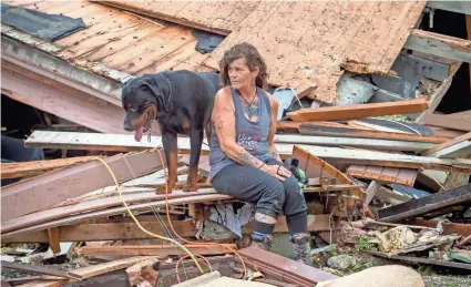  ?? TODAY NETWORK SCOTT CLAUSE/USA ?? Fran Tribe and her dog Dave sit outside a home destroyed by Hurricane Ida in Houma, La., on Monday.