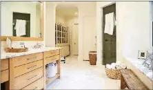  ??  ?? The fresh, neutral tones in the rest of the home flow into Dana and Angelo Spinola’s master bathroom, giving the space a clean look. A sliding hutch off to the side houses Dana’s shoes.