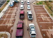  ?? Rory Doyle / New York Times ?? A drive-thru vaccinatio­n line fills up in Cleveland, Miss. The new stimulus includes billions to ramp up vaccinatio­ns.