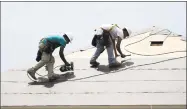  ?? Associated Press ?? Constructi­on workers put down roofing paper on a home in Houston. General contractor­s and other small businesses in the home remodeling industry can expect revenue to slow in 2019, the result of rising mortgage rates and sluggish home sales.