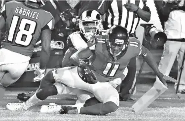  ?? Associated Press ?? Atlanta Falcons wide receiver Julio Jones catches a touchdown pass past Los Angeles Rams defender John Johnson III during the fourth quarter of an NFL football wild-card playoff game Saturday in Los Angeles.