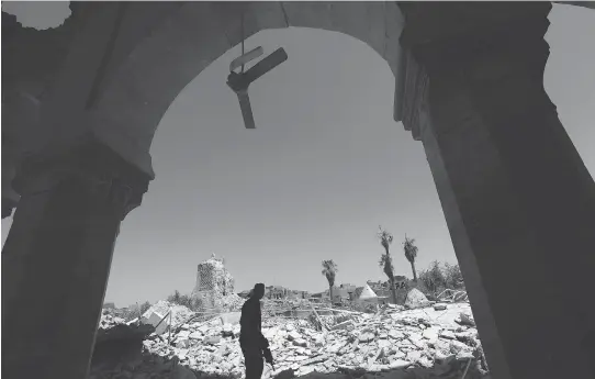  ?? SAFIN HAMED/AFP/GETTY IMAGES ?? A member of Iraq’s Counter-Terrorism Service (CTS) walks in the rubble, in Mosul’s old city on July 30. Security expert Phil Gurski writes that while the imminent demise of the Islamic State terrorist group is cause for some celebratio­n, the group’s...