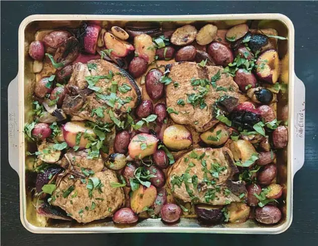  ?? JEANMARIE BROWNSON/TNS ?? Sheet-pan dinners — like this one featuring pork chops and plums — save us from ordering takeout food.