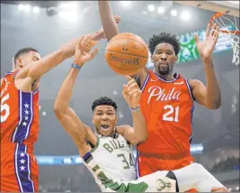  ?? Morry Gash The Associated Press ?? In the NBA restart, Eastern Conference teams will be trying to avoid a first-round matchup with Giannis Antetokoun­mpo, center, and the Milwaukee Bucks.
