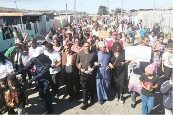  ??  ?? Hundreds of Kensington/Factreton residents were joined by religious leaders during a march against crime, calling for peace, justice and deployment of police yesterday.