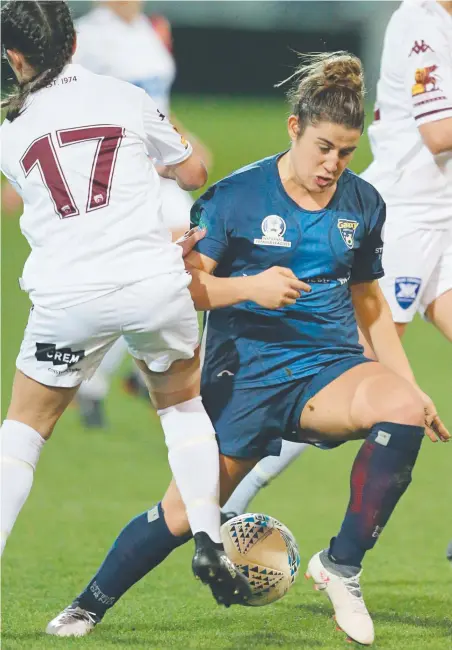  ?? Picture: MARK WILSON ?? FAST FEET: Galaxy United’s Adriana Taranto tries to get around Bulleen’s Daniela Gudelj at Kardinia Park on Saturday night as part of a bumper day of female soccer matches at the ground.