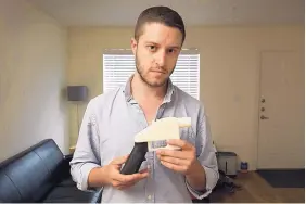  ?? JAY JANNER/AUSTIN AMERICAN-STATESMAN ?? Cody Wilson, founder of Defense Distribute­d, displays a plastic handgun made on a 3D printer at his home in Austin, Texas.