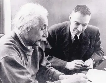  ?? COURTESY OF NATIONAL ARCHIVES ?? Albert Einstein, left, the most famous scientist of his era, confers in 1950 with J. Robert Oppenheime­r, the physicist who directed the scientific team that built the first atomic bombs at Los Alamos.