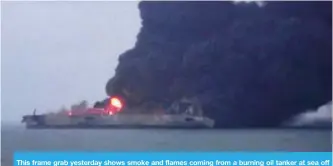 ??  ?? This frame grab yesterday shows smoke and flames coming from a burning oil tanker at sea off the coast of eastern China. — AFP