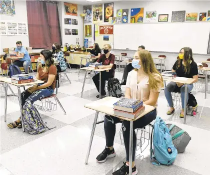  ?? JACQUELINE DORMER/REPUBLICAN HERALD ?? Students are spaced 6 feet apart due to coronaviru­s concerns in Dan Blydenburg­h’s 11th grade English class on the first day of school Aug. 27 at Pine Grove Area High School in Pine Grove, Pennsylvan­ia.