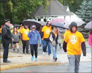  ??  ?? Woonsocket Police Chief Thomas Oates, left, wishes the walkers well at the start of the 30th annual Shelter Walk at River Island Park Saturday morning.