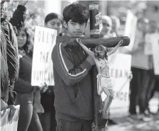  ??  ?? Gabriel Roblas, 12, joined his family in a civil protest against the potential selling of St. Stephen’s education building.