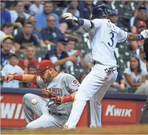  ?? BENNY SIEU/USA TODAY ?? Orlando Arcia advances to third after a wild pitch as Cincinnati’s Eugenio Suarez bobbles the ball in the sixth.