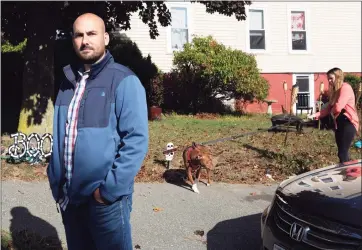  ?? Associated Press ?? Real estate investor Shad Elia outside one of his properties as tenant Krystal Dingler walks her dog on Thursday in Haverhill, Mass. Elia says government stimulus benefits have allowed his hard-hit tenants to continue to pay rent.