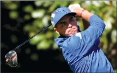  ?? JEFF SINER/TRIBUNE NEWS SERVICE ?? Rickie Fowler follows through on his drive from the 11th tee during the second round of the Masters on Friday.