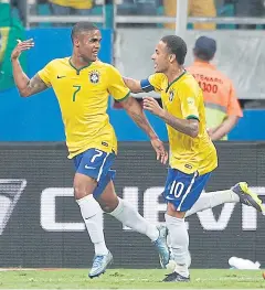  ?? AP ?? Brazil’s Douglas Costa, left, scores his team’s opening goal against Peru.