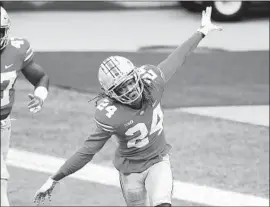  ?? SHAUN WADE Jay LaPrete Associated Press ?? of Ohio State takes f light after returning an intercepti­on for a score at the end of the third quarter, a costly mistake by Indiana’s quarterbac­k.