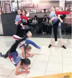  ??  ?? The dancers practise their moves while stuck at Birmingham Airport