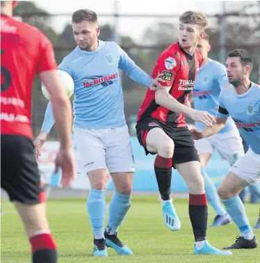  ??  ?? Spot of trouble: Ballymena midfielder Ryan Harpur concedes a penalty as the ball strikes his arm