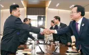  ?? SOUTH KOREA UNIFICATIO­N MINISTRY VIA AP ?? Leaders of Olympic delegation­s from South Korea (right) and North Korea shake hands Wednesday. It was their third meeting in about 10 days on cooperatio­n in next month’s winter Olympics.