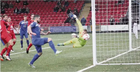  ?? Picture: KEVIN OWEN ?? Jamie Reed (blue) goes close for Bangor City against Newtown at Latham Park