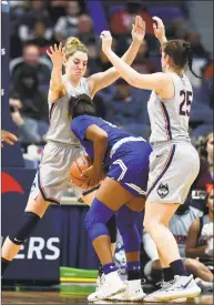  ?? Stephen Dunn / Associated Press ?? UConn’s Katie Lou Samuelson, left, and Kyla Irwin double-team Seton Hall’s Femi Funeus on Saturday.