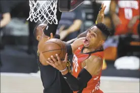  ?? AP file photo ?? The Rockets’ Russell Westbrook goes up for a shot against the Lakers’ LeBron James during a playoff game in September.