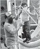  ?? AMY DAVIS/BALTIMORE SUN ?? Robert Scott of Glen Burnie helps his son, Kingston, 3, explore the play equipment at Kinder Farm Park while wearing masks last week.