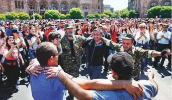  ?? Reuters ?? Armenian opposition supporters dance on the street after protest movement leader Nikol Pashinyan announced a nationwide campaign of civil disobedien­ce in Yerevan yesterday.