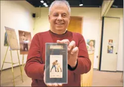  ?? DESIREE ANSTEY/ JOURNAL PIONEER ?? Author and historian Jim Hornby displays an old tobacco card that shows George Godfrey, from Charlottet­own, fight a boxing round against Joe Lannon, in Boston, April 28, 1886. Godfrey defeated Lannon. His winnings totalled $4,000.