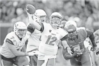  ?? JEROME MIRON, USA TODAY SPORTS ?? Liberty quarterbac­k Stephen Calvert (12) passes against Baylor in Waco, Texas, on Sept. 2.