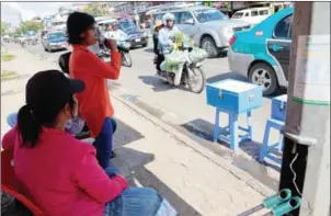  ?? SRENG MENG SRUN ?? A blind woman sings for donations on the side of a road in Phnom Penh. A recent research paper says that failure among foreign donors to take into account the Kingdom’s cultural attitudes towards disability often results in less effective interventi­on...