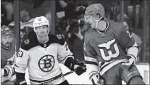  ?? AP FILE PHOTO ?? Sebastian Aho of the Carolina Hurricanes, right, celebrates his goal as Joakim Nordstrom of the Boston Bruins looks on during a 2018 game. In this game, the Hurricanes wore the Whalers jersey to honor the team’s Hartford past.