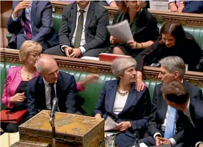  ?? AP ?? Prime Minister Theresa May is congratula­ted by Conservati­ve Party ministers in the House of Commons after speaking at the start of a fiveday debate on the Brexit European Union Withdrawal Agreement.
