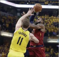  ?? DARRON CUMMINGS — THE ASSOCIATED PRESS ?? LeBron James heads to the basket past the Pacers’ Domantas Sabonis, during the first half of Game 6 of a first-round NBA playoff series on April 27 in Indianapol­is.