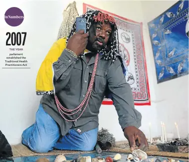  ?? Picture: Jackie Clausen ?? Sangoma Elliot Ndlovu also uses cellphones and computers to communicat­e with clients.
