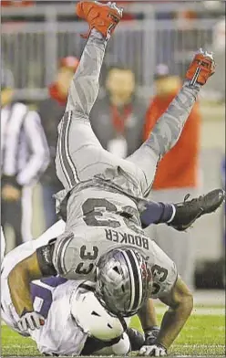  ?? Columbus Dispatch ?? Ohio State’s Dante Booker tackles Penn State star Saquon Barkley during Buckeyes’ thrilling victory Saturday night.