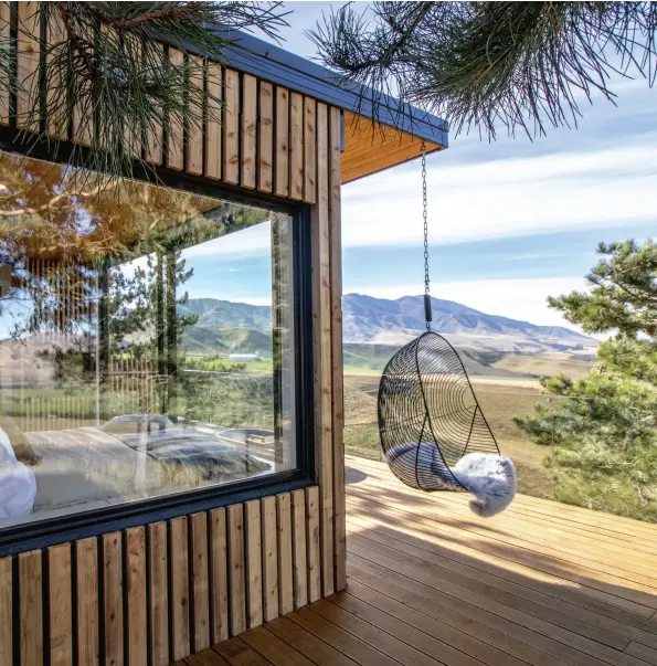  ??  ?? ABOVE An expansive wood deck, complete with inbuilt hot tub, surrounds the dwelling, allowing guests to be immersed amongst the treetops and soak in the surroundin­g rural vistas. An
Ico Traders Hokianga Hanging Chair is the perfect place to sit back and take in the star-filled night sky.