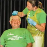  ?? (left) Photos Michael Donnelly ?? Eddie and Tom O’Donohgue getting their hair dyed green at Caherdanie­l village hall to raise awareness of motor neurone disease.