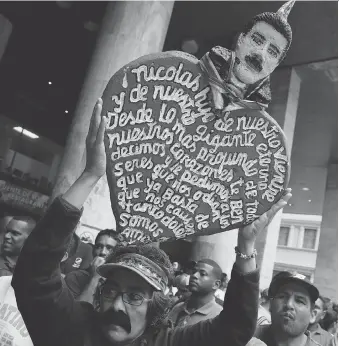  ?? RICARDO MAZALAN/THE ASSOCIATED PRESS ?? A man proclaims support Tuesday in Caracas for Nicolas Maduro, who returned to power on the weekend in the Venezuelan presidenti­al election. U.S. Gulf Coast refineries could soon process more Canadian crude as Venezuelan production declines further...