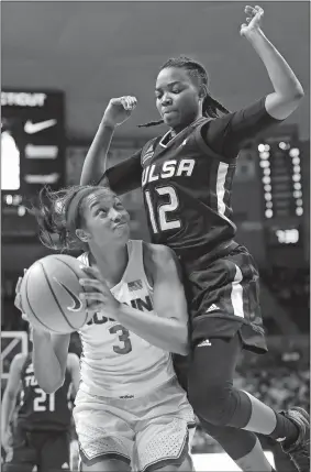  ?? JESSICA HILL/AP PHOTO ?? Tulsa’s Shug Dickson, top, fouls, UConn’s Megan Walker during the first half of Thursday’s game in Storrs. The No. 1 Huskies won 78-60.