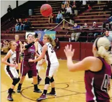  ?? RANDY MOLL NWA MEDIA ?? Lincoln’s Hayle Sugg fires a pass away from a triple team in the highpost to Courtney Lloyd on the low block. The Lincoln girls prevailed, 29-26, to win their conference opener at Gentry on Dec. 16.