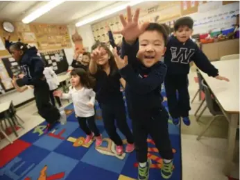  ?? VINCE TALOTTA PHOTOS/TORONTO STAR ?? Jaejin Jung, right, and his JK/SK schoolmate­s participat­e in daily physical activity at St. Wilfrid Catholic School.