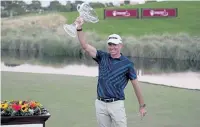  ?? John Locher, The Associated Press ?? Martin Laird, a Colorado State alumnus, celebrates with the trophy after winning the Shriners Hospitals for Children Open golf tournament Sunday in Las Vegas.