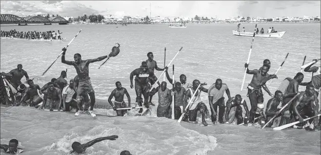  ?? AFP ?? A pirogue team celebrates winning a race in Saint-Louis, Senegal, on Saturday. Hundreds of thousands of supporters descend onto the banks of the Senegalese River to watch traditiona­l pirogue racing, which is believed to date back around 200 years and features fishermen from local neighborho­ods.