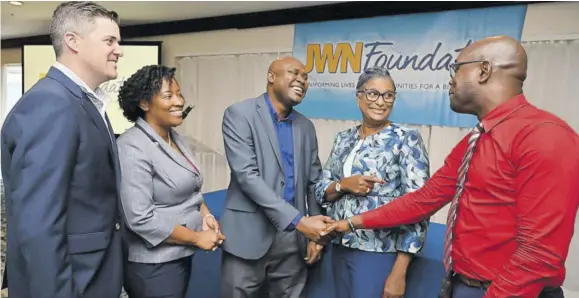  ?? ?? From left: Robert “Bobby” Alderson Jr, public affairs officer at the United States Embassy; Tanikie Mcclarthy Allen, CEO of the JWN Foundation; Paul Irving, programme manager at the LASCO Chin Foundation; and greet Monica Smiley, principal of Race Course Primary, and Dennis Thomas, guidance counsellor of York Town Primary at the refresher course for participat­ing schools of the Conflict Resolution Interventi­on.